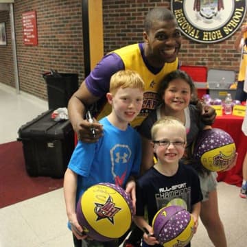 A Wizards player signed basketballs at 2014 event.