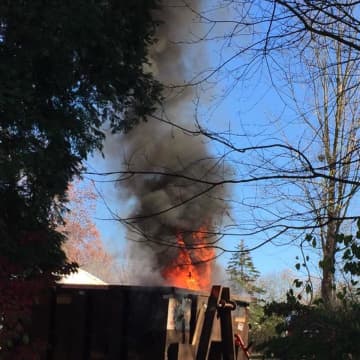 Volunteers from the Stony Hill Volunteer Fire Company put out a fire in a dumpster Saturday on Old Hawleyville Road.