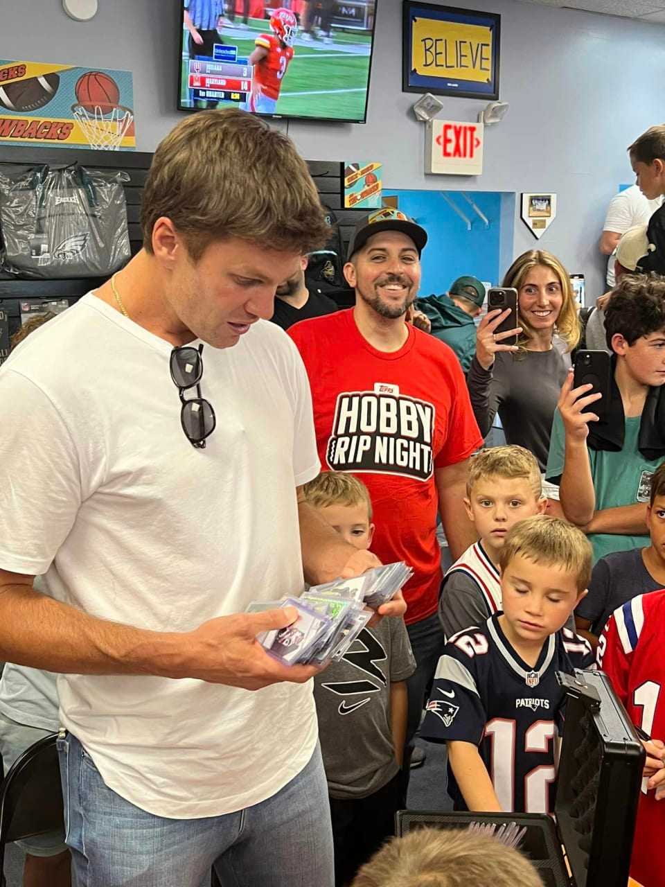 Tom Brady, Kevin Hart, Travis Scott trade cards with kids