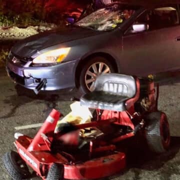 Two brothers are in critical condition after being hit by a vehicle while riding a lawnmower.