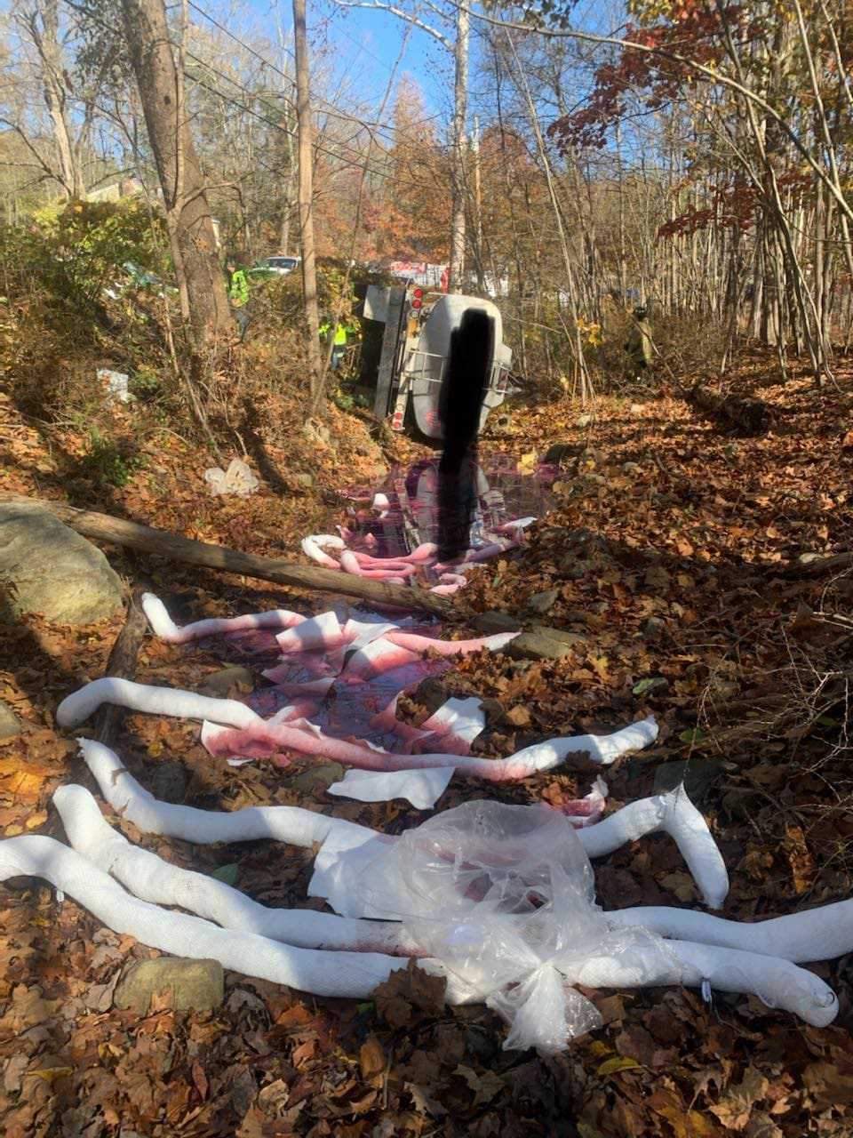 Firefighters used absorbent pads to soak up gallons of leaking oil after a tanker crash.