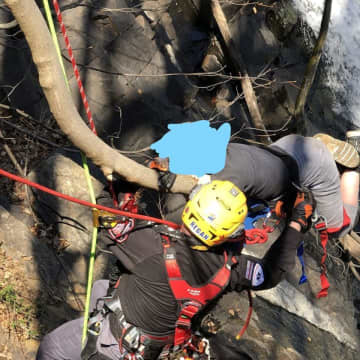 The teen -- who was not injured but couldn't move -- was on a branch of a tree sticking out of the side of a cliff approximately 50 or 60 feet above the water at the base of the dam.