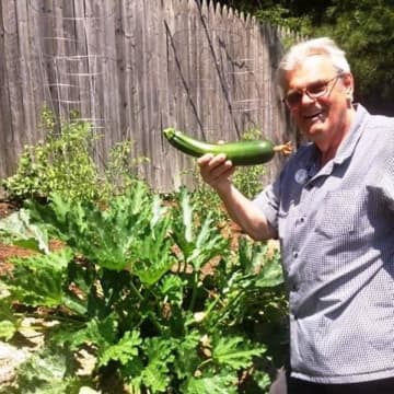 Bob Schlump holding some of the fruits of his farm.