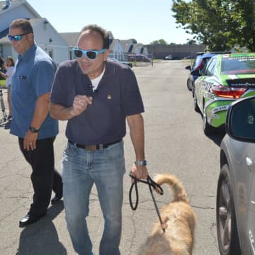 Bridgeport Mayor Joe Ganim spends quality time with his new buddy, Duke, who had just relieved himself on a car tire.