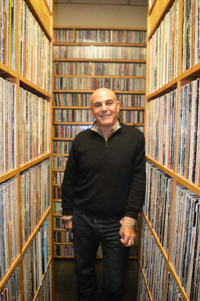General Manager Steve di Costanzo stands amid the canyons of records ready to be played at WPKN-FM of Bridgeport.