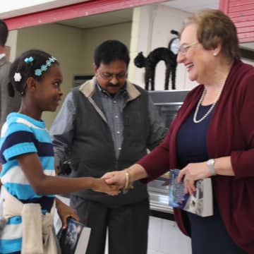 Rotarians Barbara Eannazzo and Syed Alirahi, speaking with a third-grader, presented dictionaries to each student during their visit to Alice E. Grady Elementary School.