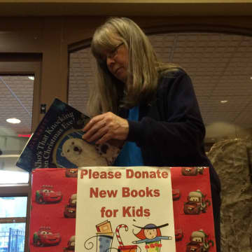 Ringwood children's Librarian Ann Marie Solch looks through donations made to the Ringwood Public Library.