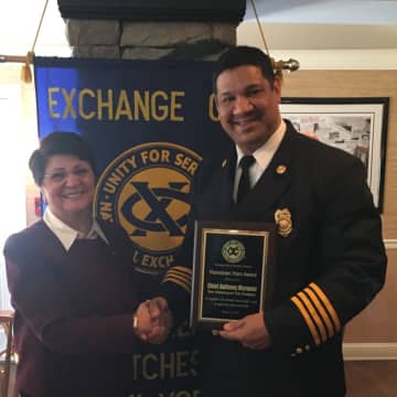 Exchange Club Secretary Pam Tarquinio recognizes Chief Marquez for his heroism.