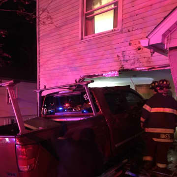 Three people suffered injuries when a pickup truck slammed into a house in Danbury early Saturday morning.