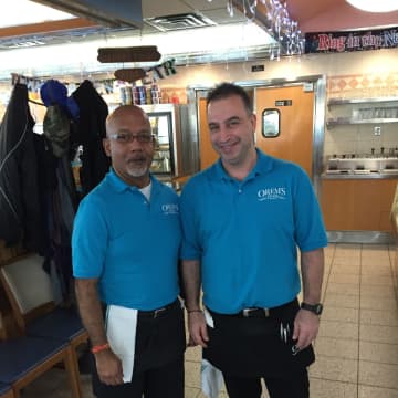 Two waiters pose in the dining room at Orem's Diner in Wilton.
