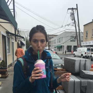 Rye resident Emily Raho tries Starbucks new unicorn frappuccino.