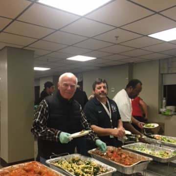 Elks Ed Flynn and Mike Picarello serve dinner for veterans at the Montrose VA.