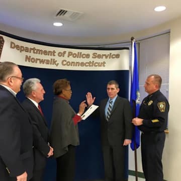 Norwalk Police Department officer Jim Mosher gets promoted to sergeant in a ceremony on Monday.
