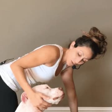 Aline Marie, founder of The Newtown Yoga Center, with her Scott American Bulldog, Truth Lightening, aka Piggy Smalls.