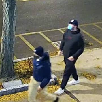 The Westchester District Attorney's Office released photos of two suspects who allegedly spread the stickers.
