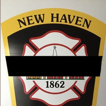 A New Haven firefighter was killed and three others injured, one critically, battling a house fire.