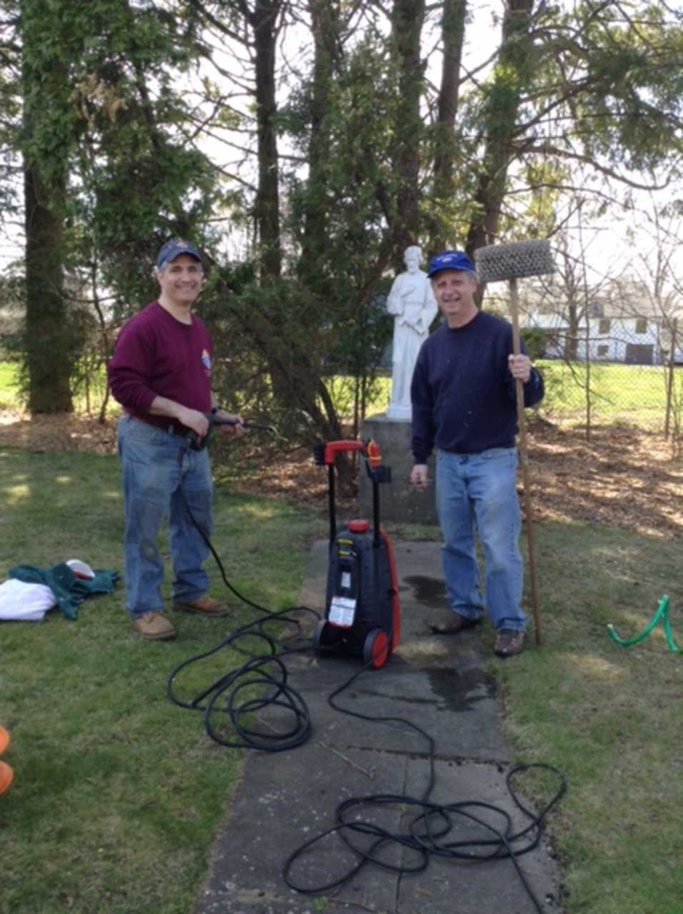 Past Grand Knight Mike Colaluca and Trustee Lee Pino clear the grounds of Notre Dame Convalescent Home.