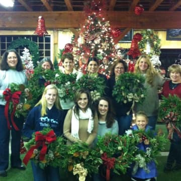 Families posing with their wreaths at 2014 event.