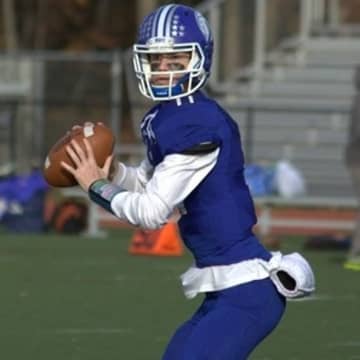 Darien quarterback Tim Graham led the Blue Wave to the FCIAC title, defeating archrival New Canaan in a game Thursday at Boyle Stadium in Stamford. 