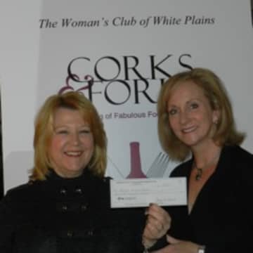 Maryann Martin, chairwoman of the Womans Club of White Plains  Corks & Forks event presents Kathleen Bonistall of PEACE OUTside Campus with a check for $7,500.  