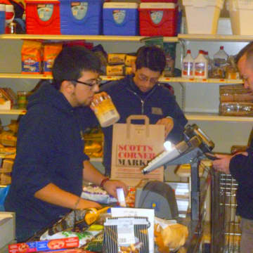 Scotts Corner Market staff check out customers Monday morning. They've been very busy since Saturday morning.