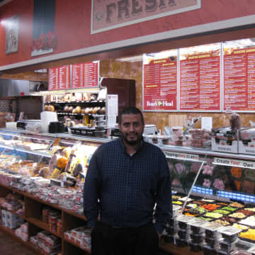 Ardsley Market Fresh owner Jamal Alrubai stands in front of his deli, which offers more than 75 sandwich options.