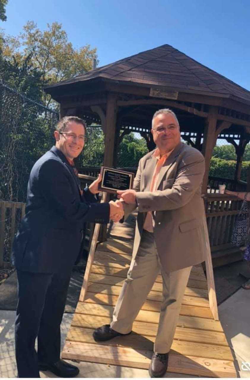 Doug DiPaola, right, receives an award from Paramus Home for Veterans CEO Matthew Schottlander after fixing the gazebo and building the ramp last summer.