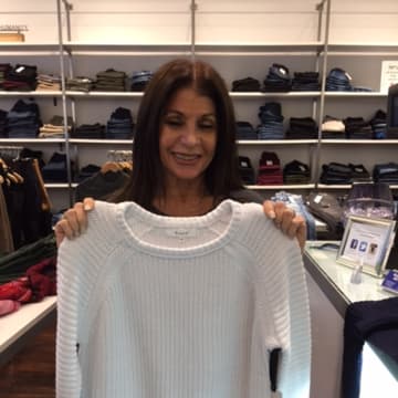 Sheryl Blit shows off one of the great sweaters in her store, Havana Jeans