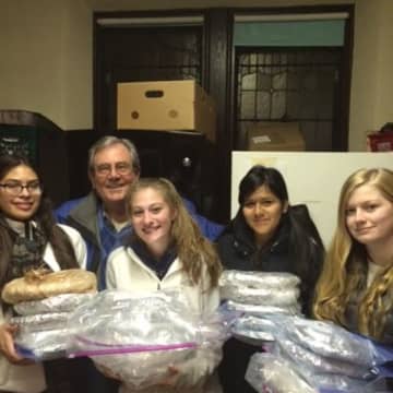 Martin Engelhardt Jr., president of the Ossining Food Pantry, accepts the donation of fresh-baked pies from local Girl Scouts Catherine Kamp, Samantha Santiago, Jessica Quizphi and Michelle Zaruma.