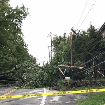 A fallen tree broke a pole and downed wires, caused by strong winds brought by Tropical Storm Isaias.