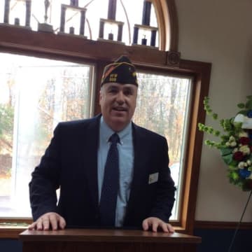 Walter Dolan, head of VFW Post 308 in Newtown, leads the Veterans Day event on Wednesday. 