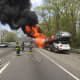 A tractor-trailer car carrier is engulfed in flames on Interstate 95.