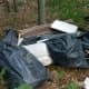 Trash dumped illegally in the Monson woods.