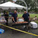 Community Police Officer Russell Ouellette and Traffic Unit Officer John Haggerty grilling some dogs.