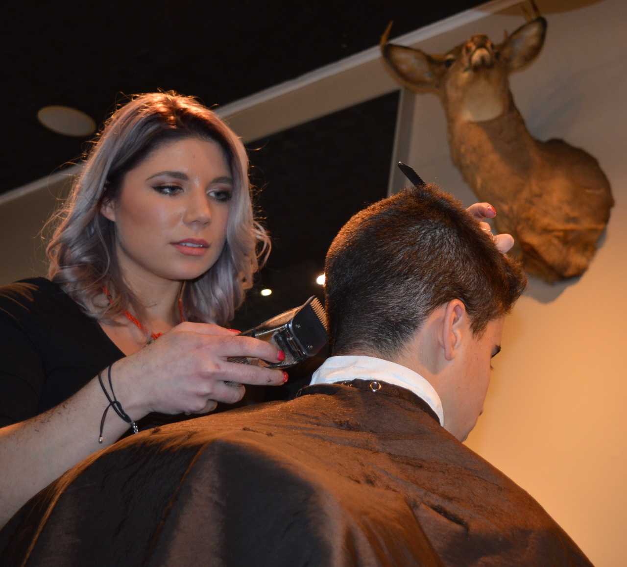 Rachel Israel gives a young client a cut at the Stag House in Glen Rock.