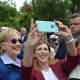 Hillary Clinton poses for a selfie moments before the start of New Castle's 2016 Memorial Day parade, which was held in downtown Chappaqua.