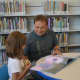 Peter Tuccino reads a book with his daughter, Emma, 6