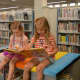 Colleen Cawley, 4, and Leah Gamable, 5, reading books in the newly improved Children's Room.