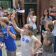 Kids with Hillary Clinton campaign stickers watch the local Memorial Day parade in downtown Chappaqua. Clinton, a Democratic presidential candidate, is a Chappaqua resident.