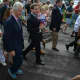 Former President Bill Clinton marches in the town of New Castle's 2016 Memorial Day parade, held in downtown Chappaqua. State Assemblyman David Buchwald, pictured at right, marches with his infant daughter.