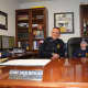 Jack and Russo sit at the chief's desk.