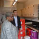 State Sen. Marilyn Moore and state Rep. Steve Stafstrom tour the science preparation lab at Geraldine Claytor Magnet Academy.