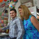 Darwin Aguirre Portillo cuts a celebratory cake after winning a $2.5 million lottery prize.
