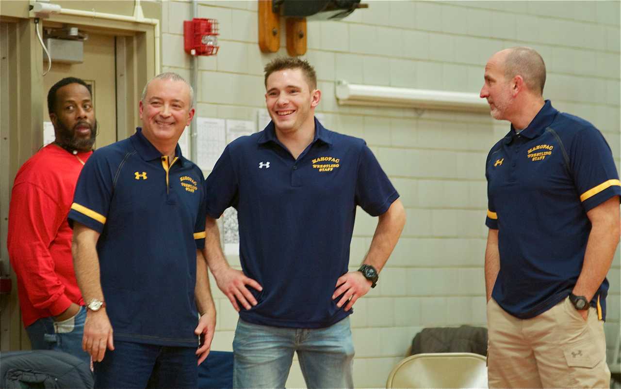 Mahopac Head Coach Dennis DiSanto (L) and Mahopac coaches watch the action.
