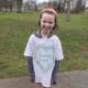 A soaking wet little girl is still all smiles in her Sandy Hook T-shirt after Saturday's kids race.