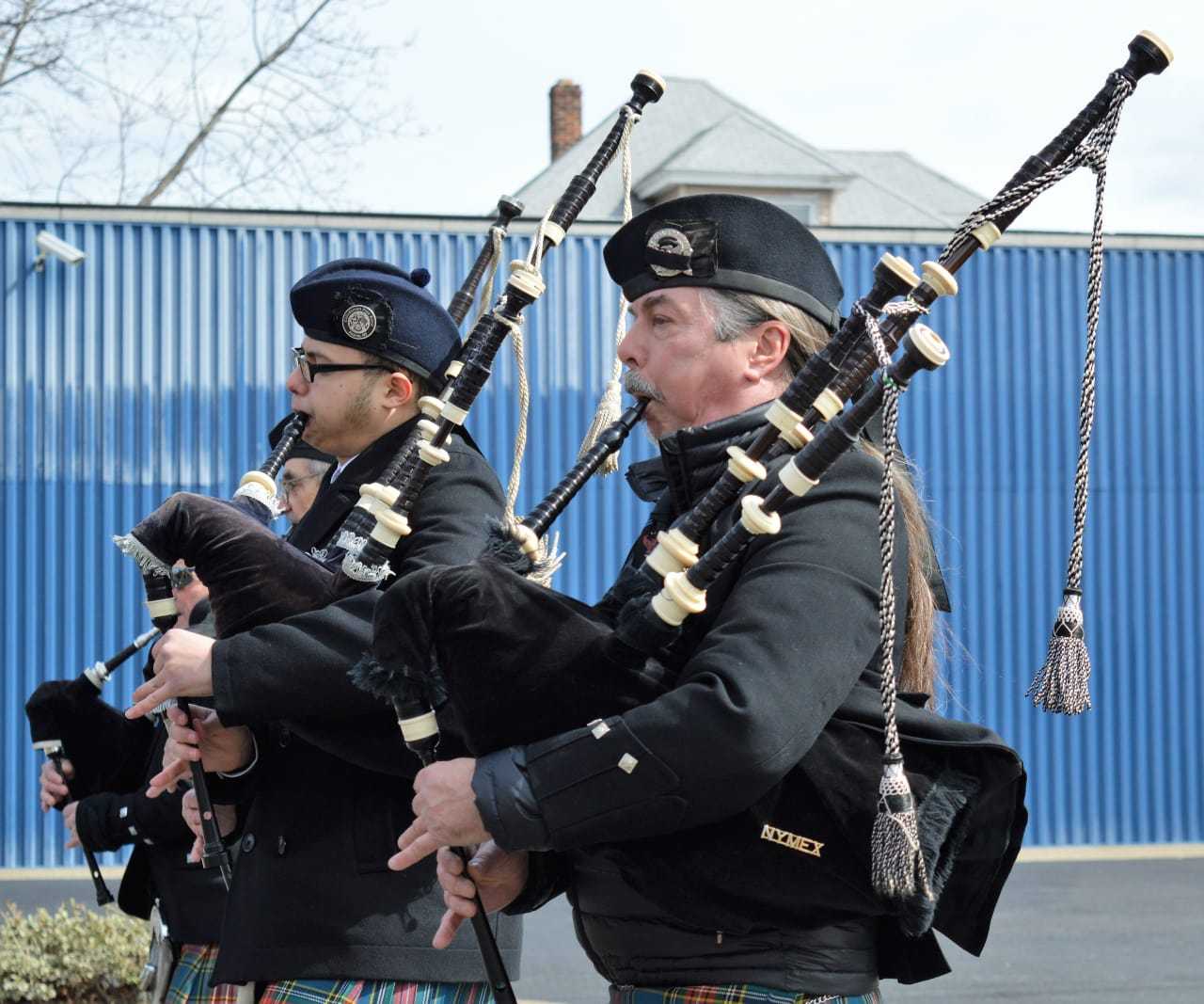 Bagpipers marching up Washington Avenue.