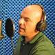 Greg Riccardi working on a voice-over in his studio.