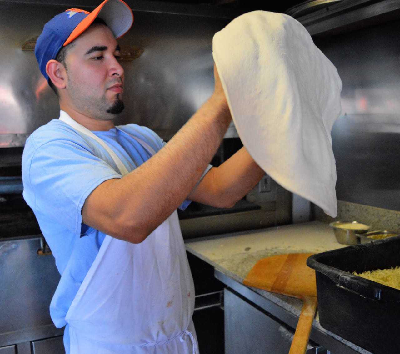 Pedro Constanza of Ridgewood working the dough.