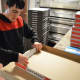On Tuesday mornings Frank Botti, 20, of ECLC in Ho-Ho-Kus puts together hundreds of pizza boxes.