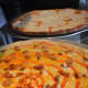 Natale's makes pizzas in lots of flavors. Here's buffalo chicken (foreground) and fresh mozzarella and vodka sauce.